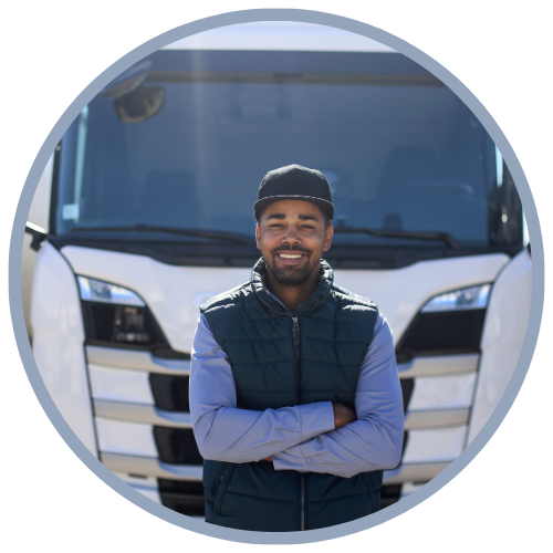 Truck driver smiling in front of white 18 wheeler truck