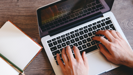 Person typing on laptop