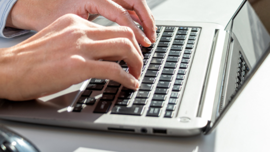 Typing on laptop
