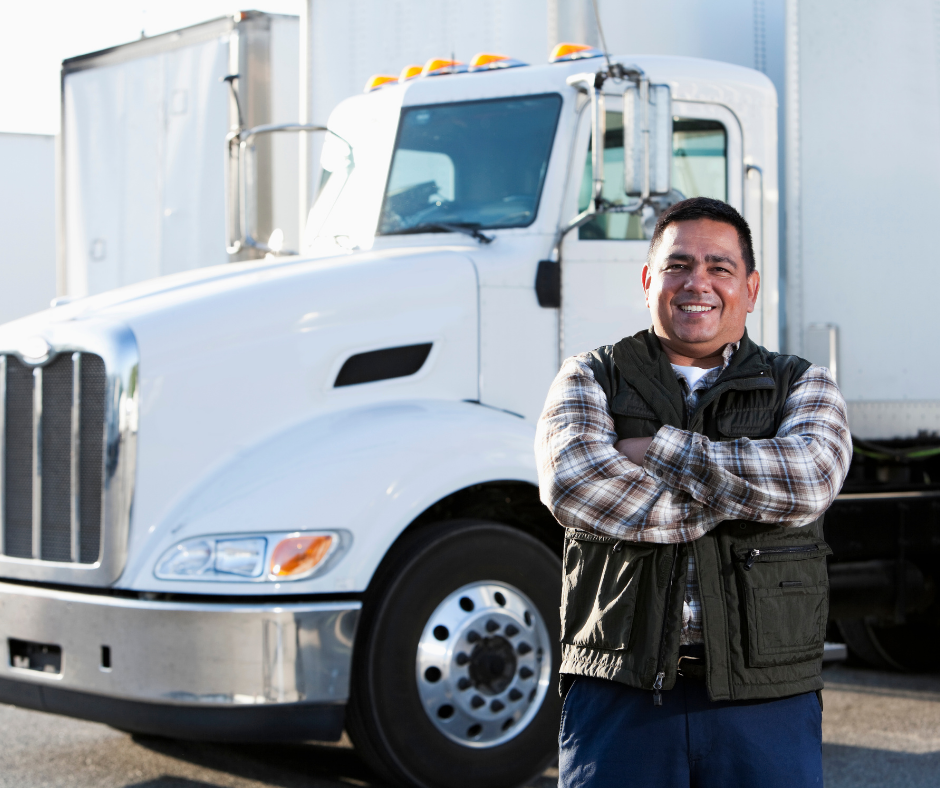 Truck driver smiling in front of truck